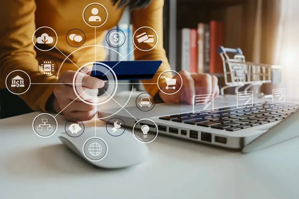 A shopper holding a bank card at a laptop, surrounded by icons for online payments, delivery and shopping